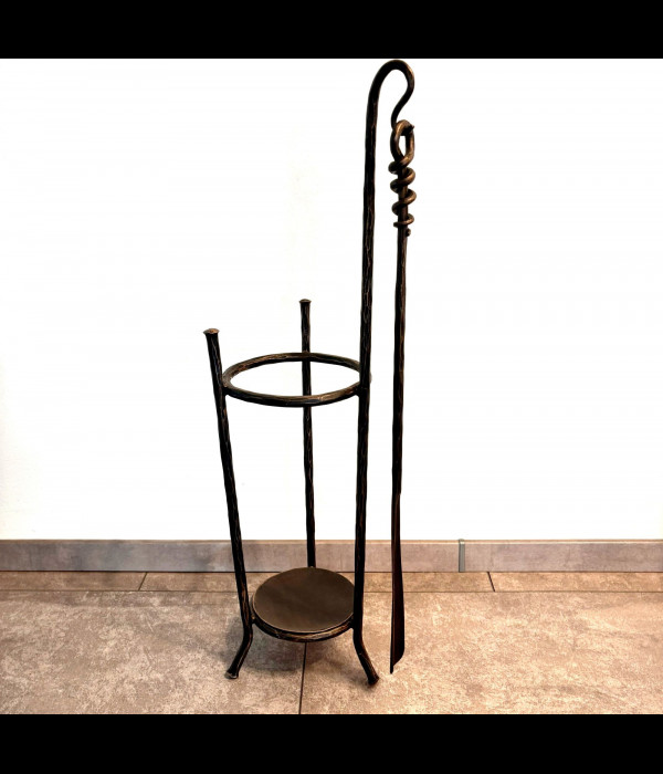 A wrought-iron umbrella stand with a shoehorn