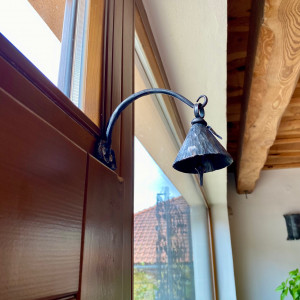 A little wrought iron bell and a console