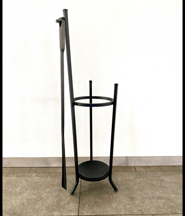 A wrought-iron umbrella stand with a forged shoehorn