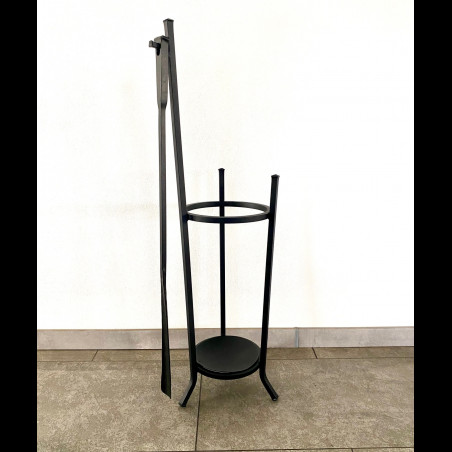 A wrought-iron umbrella stand with a forged shoehorn