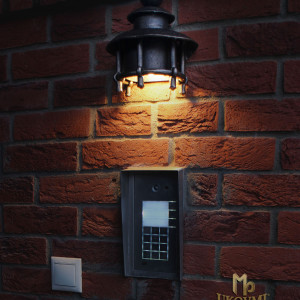 A wrought iron light above a door bell (LB-65)